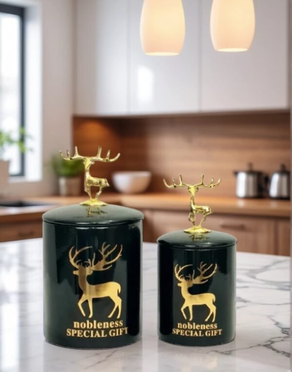 A pair of candy jars with antlers design on lid on a marble top
